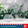 Clear acrylic reptile breeding box displayed on a white surface with green foliage in the background.