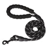 Black durable nylon dog leash with a soft padded handle coiled on a white background