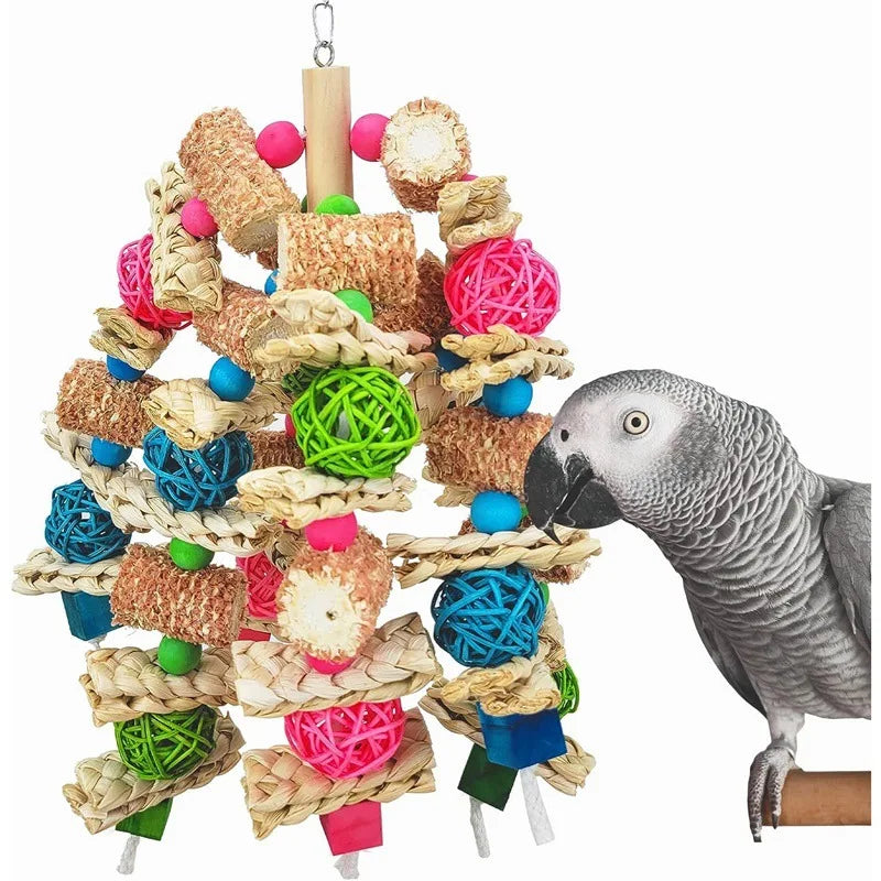 A natural wooden parrot bite toy made of woven straw and colorful foam balls hanging from a wooden dowel.