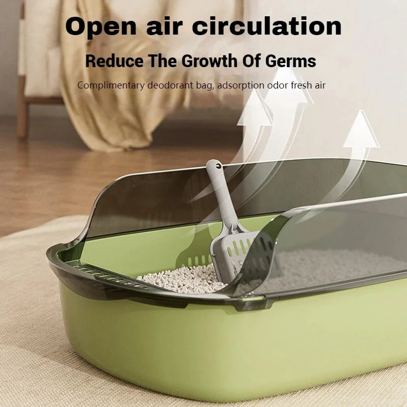 A semi-enclosed splashproof cat litter box with a scoop is shown in a light green color.