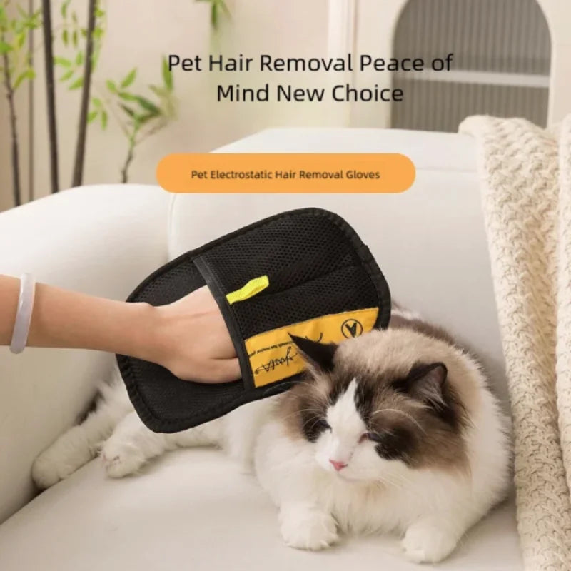 Black electrostatic hair removal gloves being used on a fluffy white and gray cat.
