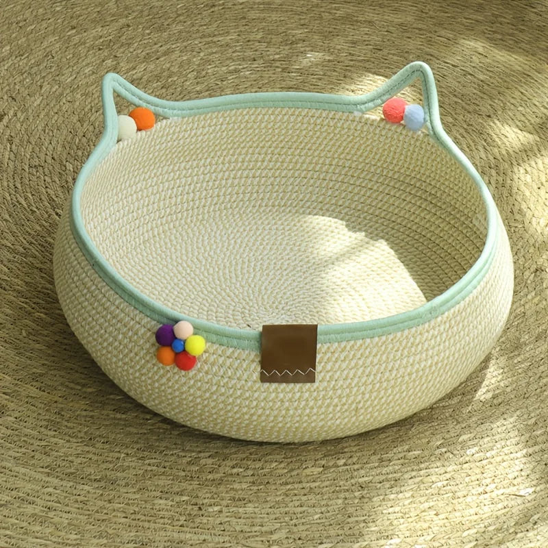 A beige cat scratcher and comfort bed with a light blue trim and colorful play balls.