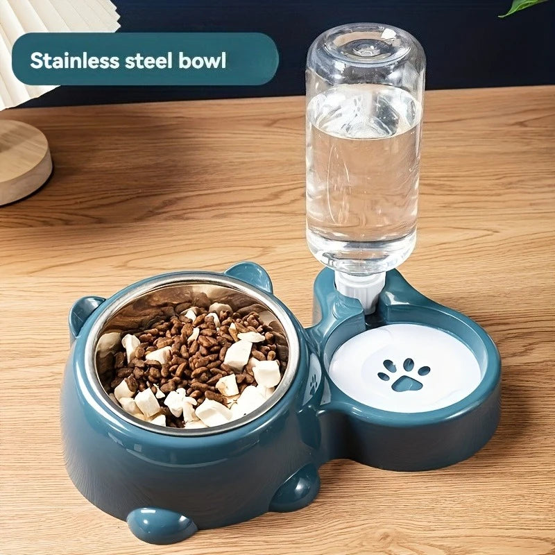 A teal gravity pet feeder and water dispenser sitting on a wooden surface with kibble and water visible.