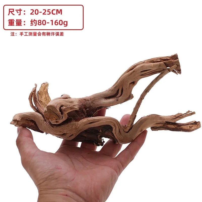 A hand holds natural driftwood branches, approximately 20-25 cm long and weighing 80-160g.