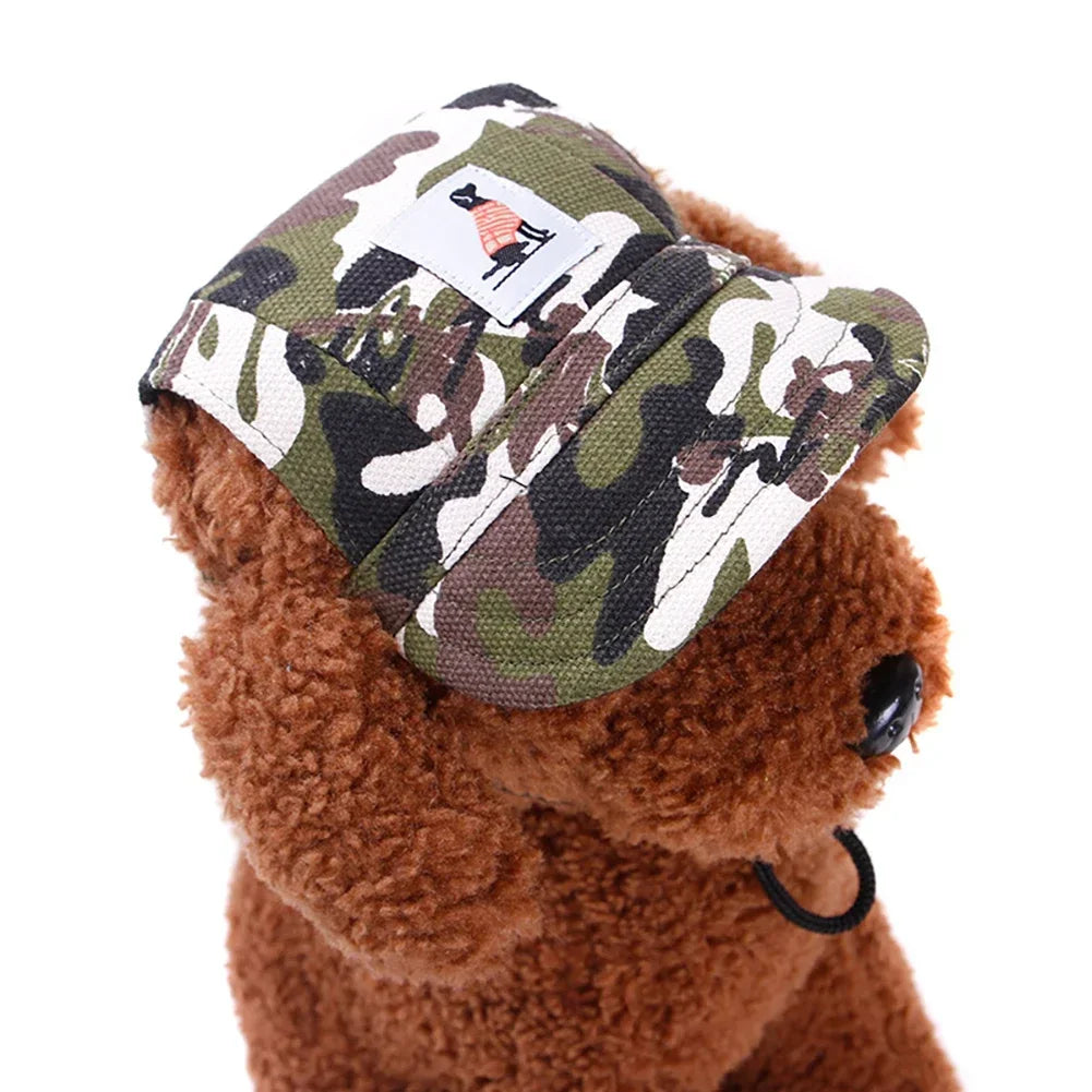 A brown teddy bear wearing a camouflage pet grooming visor cap with a white tag.
