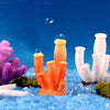 Colorful resin coral aquarium decoration with orange and white textures set against a blue background.