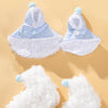 A set of white and blue plaid parrot cape and hat with fluffy trim and buttons.