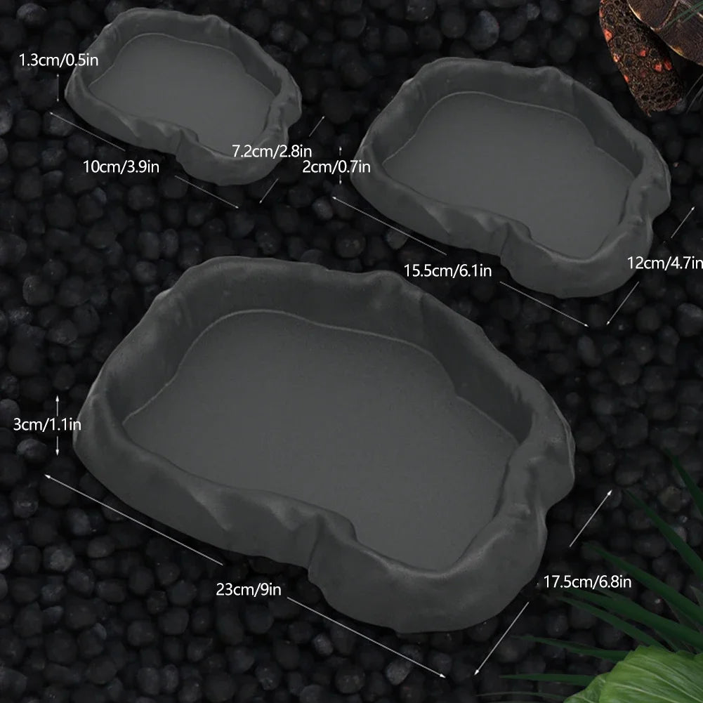 A set of natural rock reptile feeding and water dishes with various sizes shown against a dark background.