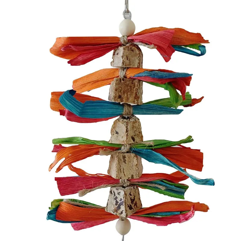 Stainless steel parrot chew toy with accent cups made of colorful fabric strips.