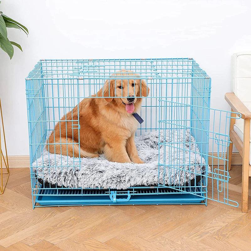 A golden retriever is resting inside a blue wire pet cage with a fluffy gray mat.
