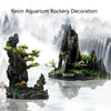 Resin aquarium rockery decoration featuring mossy rocks, a waterfall, and small trees.
