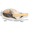 A fluffy white cat relaxing in a wooden and black striped wall-mounted hammock for climbing.