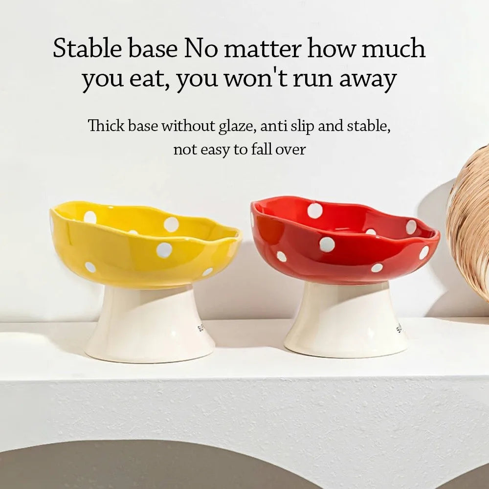 Two ceramic pet bowls, one yellow and one red, are displayed on a white shelf.