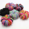 Colección de bandas elásticas para el pelo de niños en varios tonos de rosa, morado, naranja y negro.