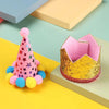 A pink conical party hat with star accents and yellow pom-poms is shown next to a gold sequin box.