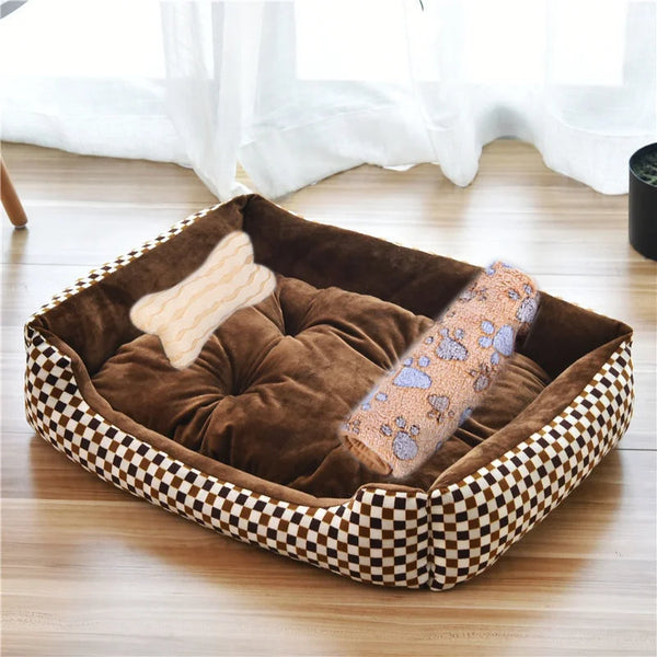 A brown velvet dog bed with a checkered border and a light tan chew toy inside, placed on a wooden floor.