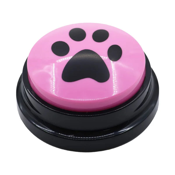 A pink pet communication button with a black paw print molded into the surface.