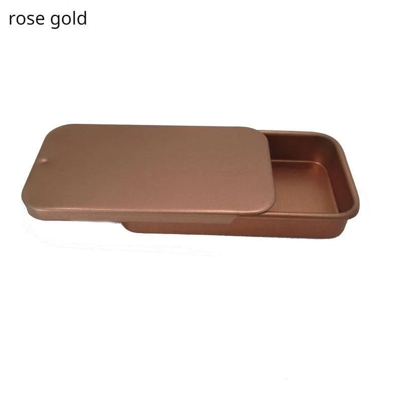 A rose gold ergonomic parrot training treat dispenser with a flat tray and a slanted compartment.