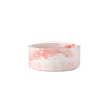 A marbled ceramic double pet bowl set with a wooden stand in pink and white tones.