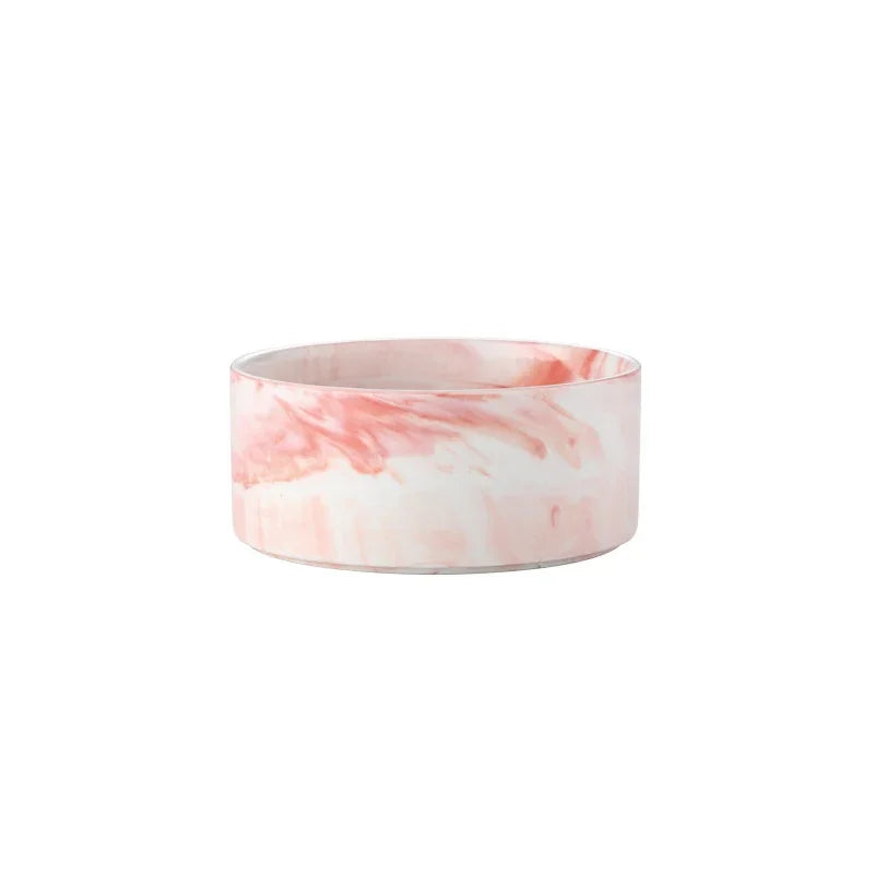 A marbled ceramic double pet bowl set with a wooden stand in pink and white tones.