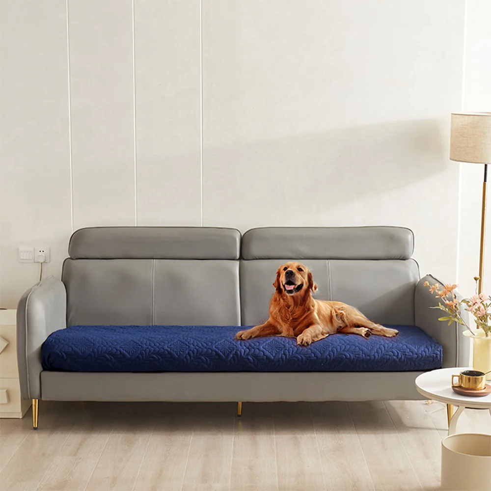 A gray sofa is covered with a blue quilted pet bed cover for dogs and cats.