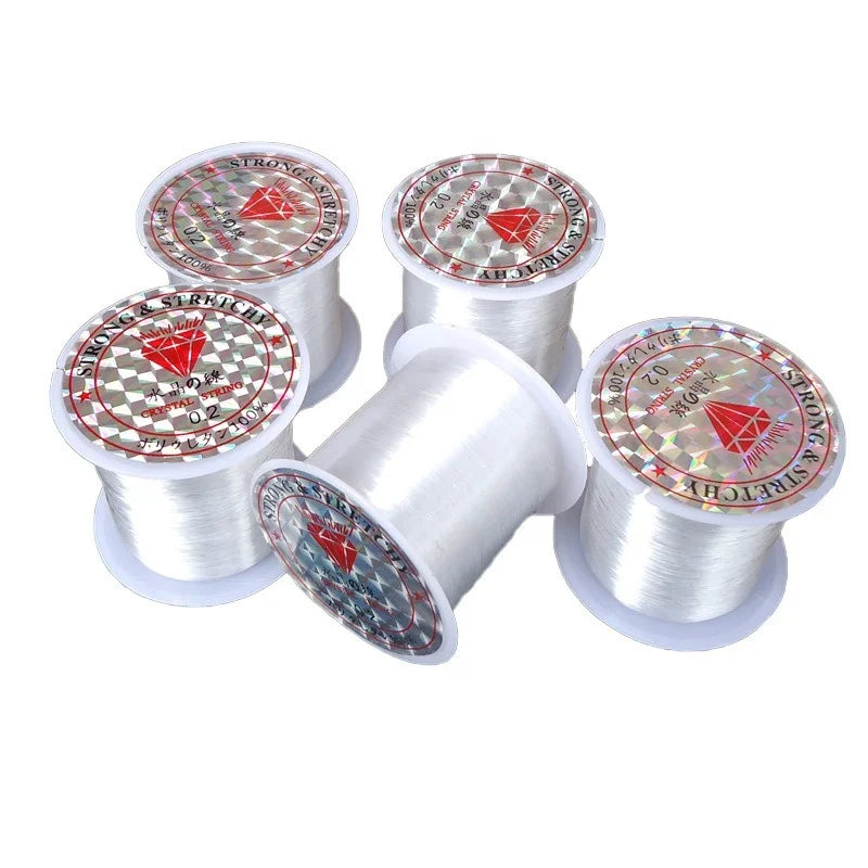 Spools of transparent nylon moss line for aquariums with red and silver markings