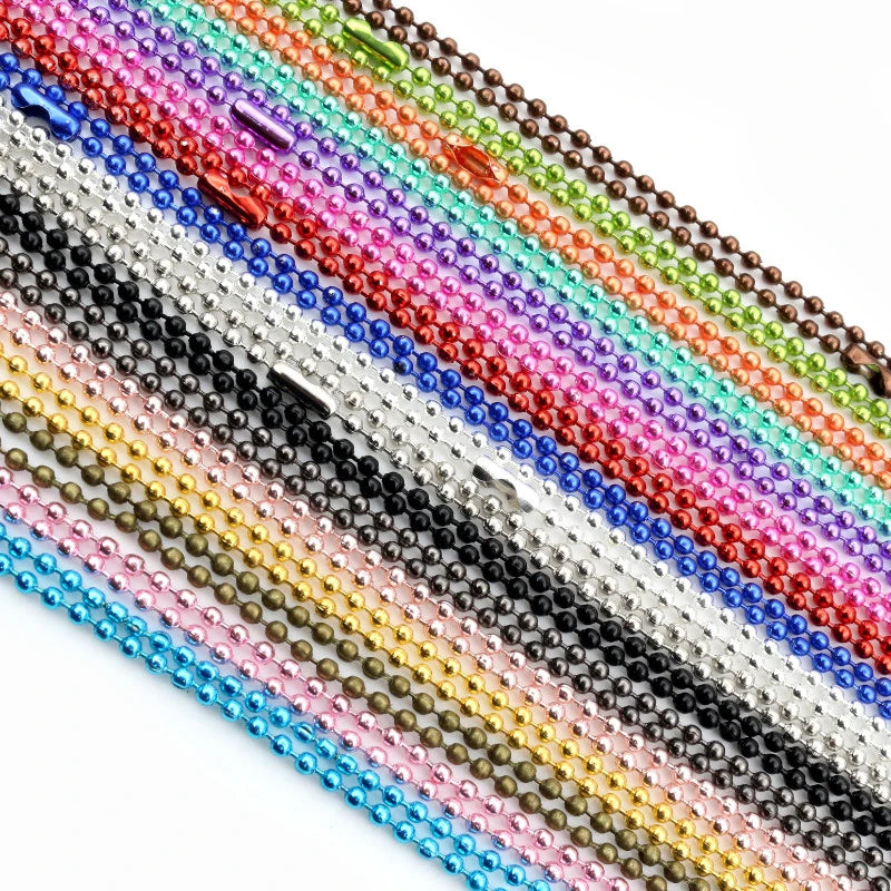 A close-up of a gold and silver plated ball necklace set featuring colorful beads.