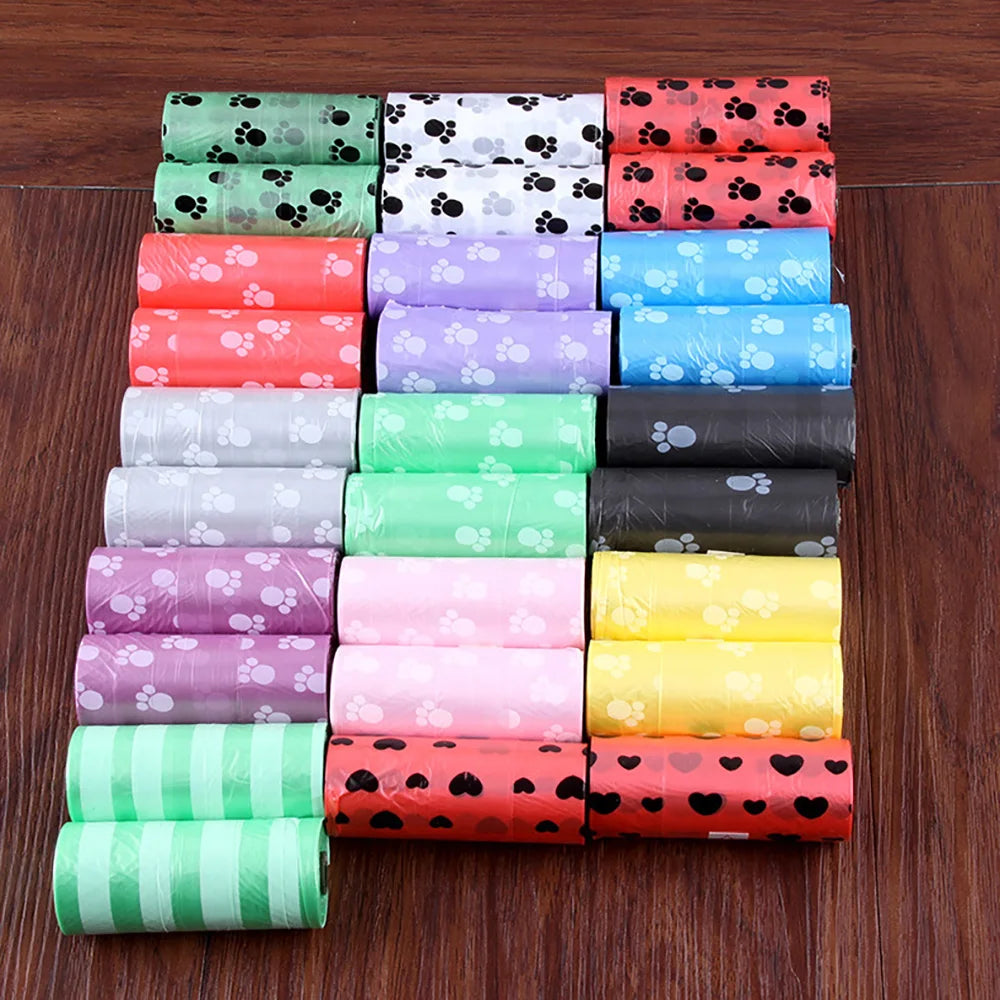 A stack of colorful reusable pet poop bags in various patterns and colors arranged vertically.