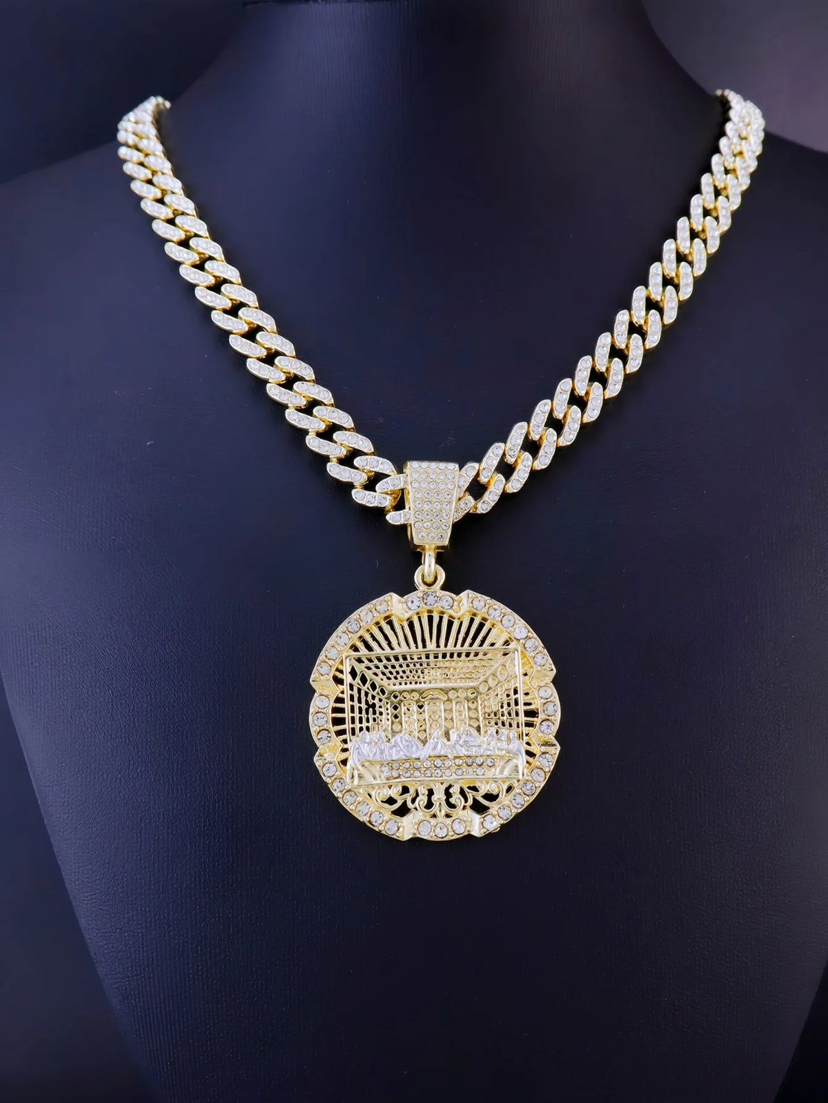 A gold plated last supper medallion necklace featuring a Cuban chain and detailed engraving.