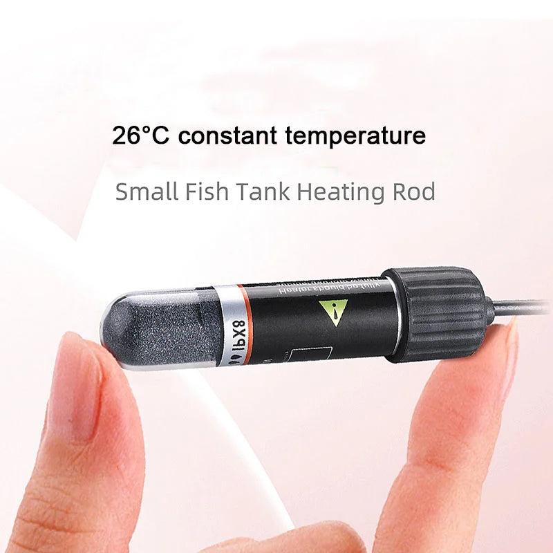 A hand holds a small fish tank heating rod with an IX8 unit, designed to maintain a 26°C constant temperature.