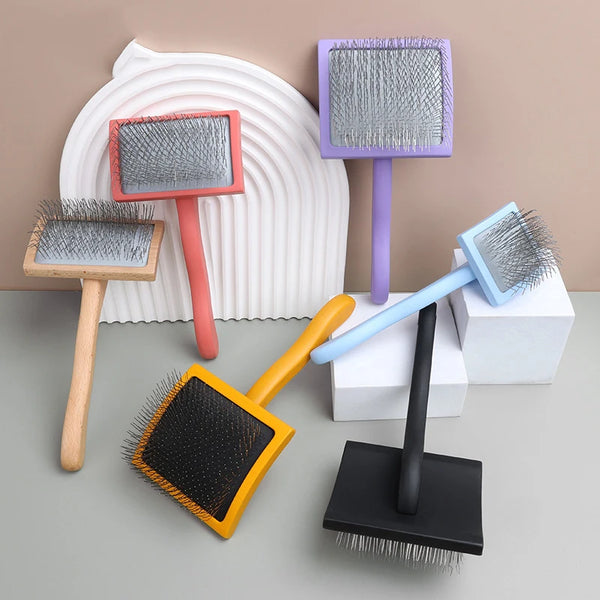 A collection of various grooming rakes and brushes with stainless steel teeth in shades of pink, purple, blue, and black.
