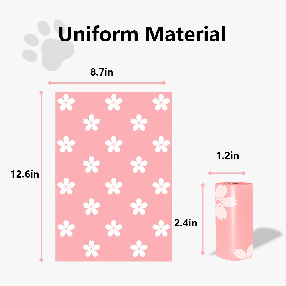 A roll of pink biodegradable pet waste bags with a dispenser, featuring a white floral pattern.