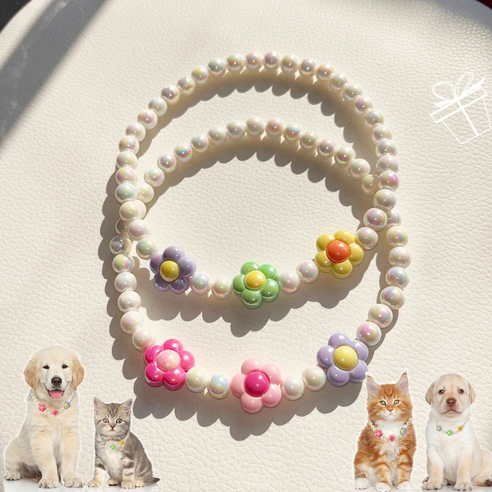 A set of pastel floral beaded pet collar necklaces displayed on a light background with small cats and a dog.
