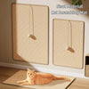 A sisal cat scratching mat is displayed on a wall, with a cat resting on a matching mat below.