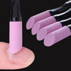 A hand holds a black nail file tool with pink buffer pads, showing the texture and size of the tools.