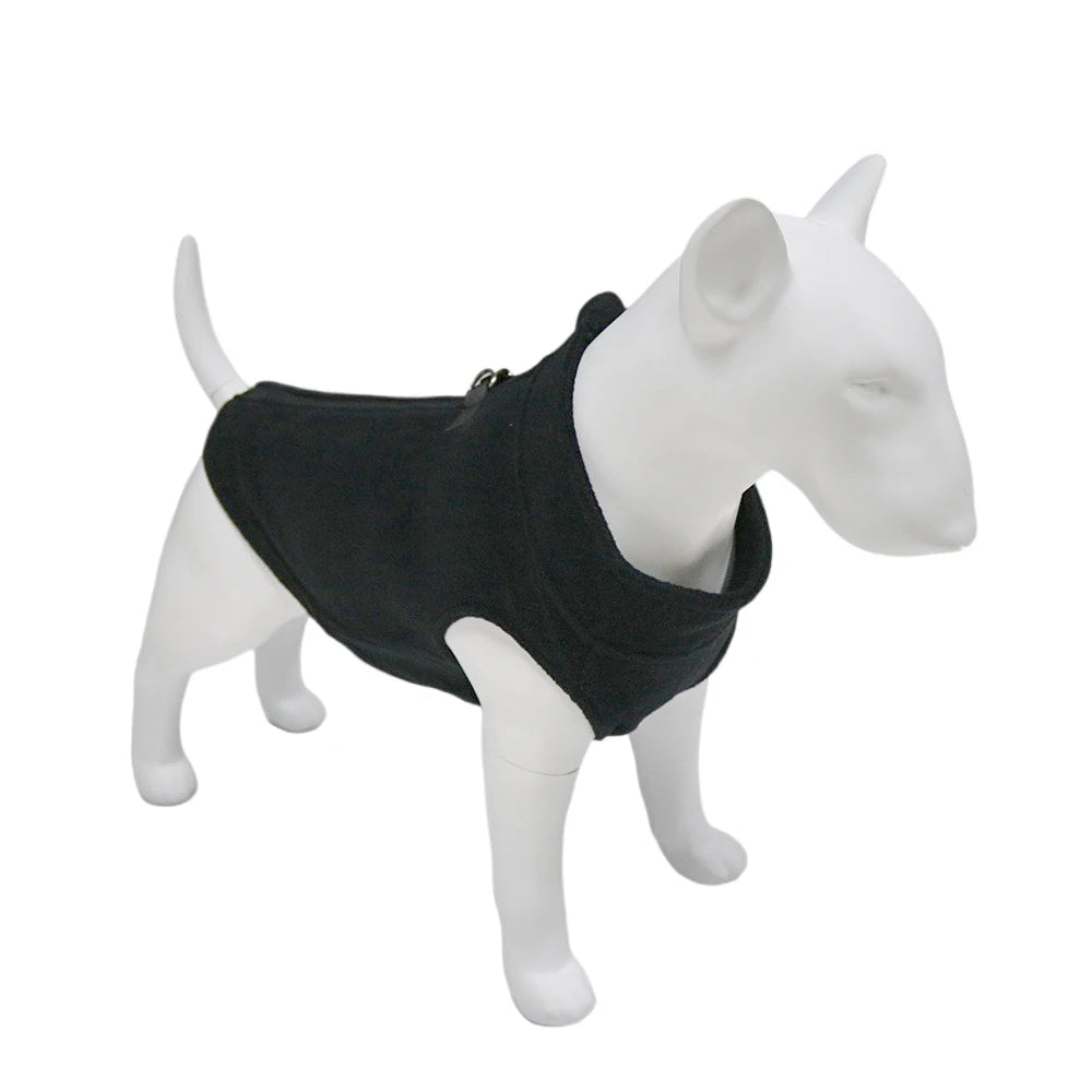 A white dog model wearing a black soft fleece vest.