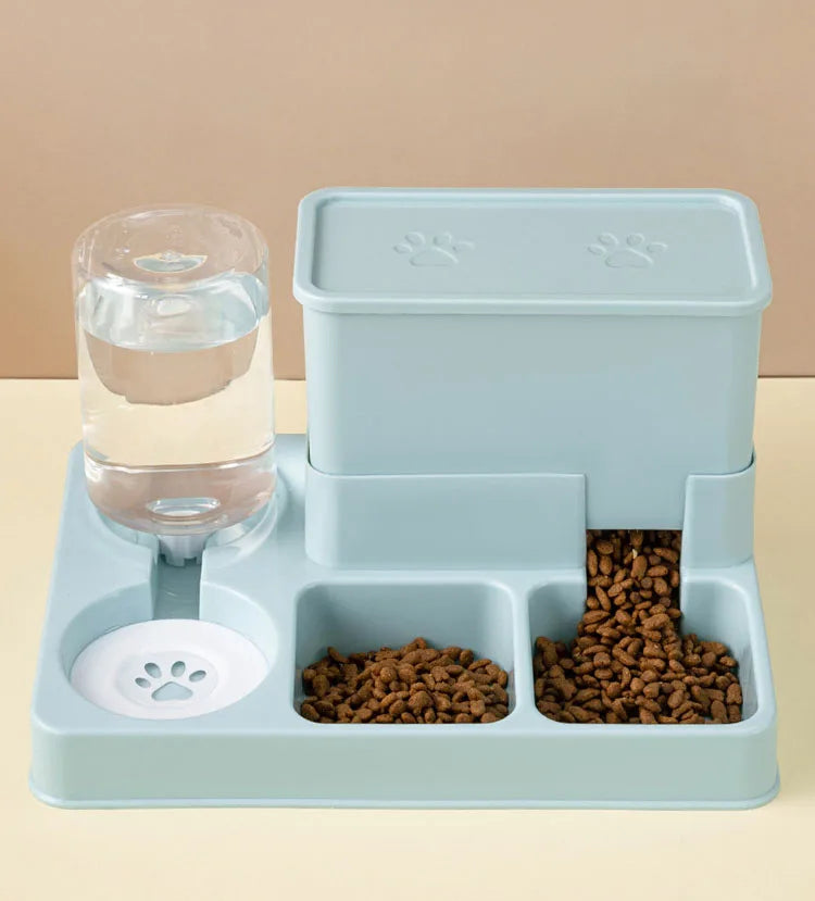 A light blue automatic cat feeder and water fountain set with a glass water bowl and food compartments.