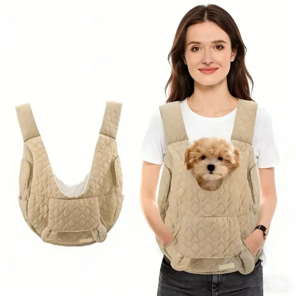 A woman is holding a beige pet carrier backpack for dogs and cats.