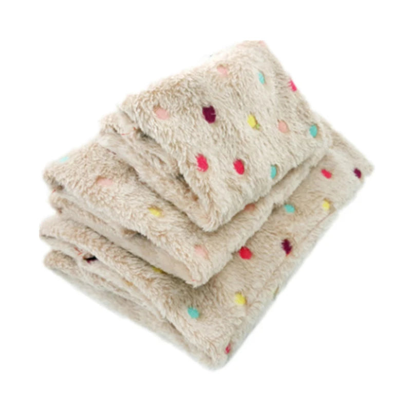 A stack of plush parrot hammock beds with light beige fur and colorful polka dots.