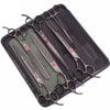 A set of professional stainless steel pet grooming scissors laid out on a black case.