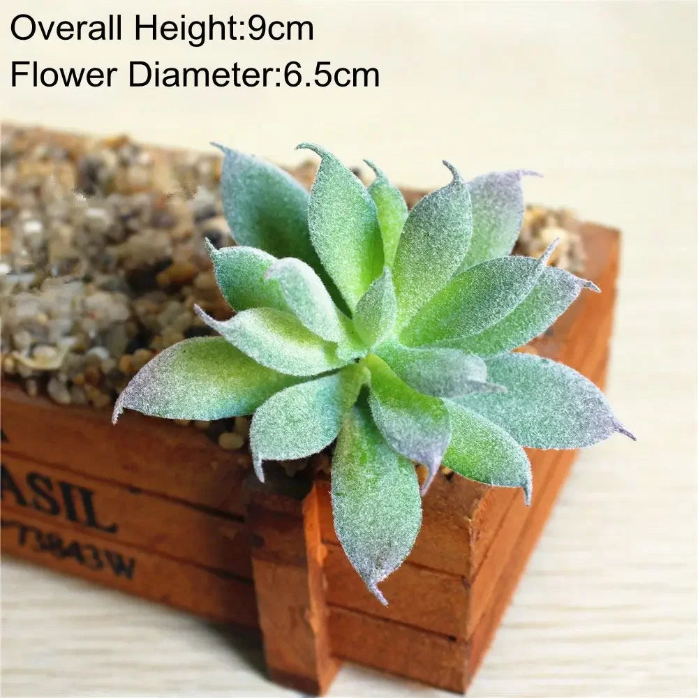 A small, flocked succulent plant with a green and purple tint is displayed in a wooden box.