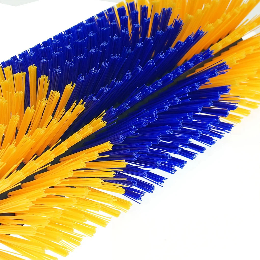 A close-up of a rotating livestock grooming brush with bristles in bright yellow and deep blue colors.