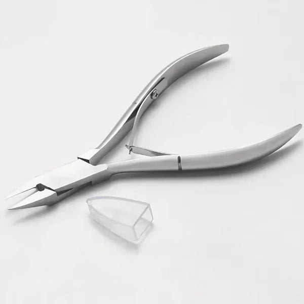 A pair of silver precision stainless steel cuticle nippers for nail care lying on a white surface.