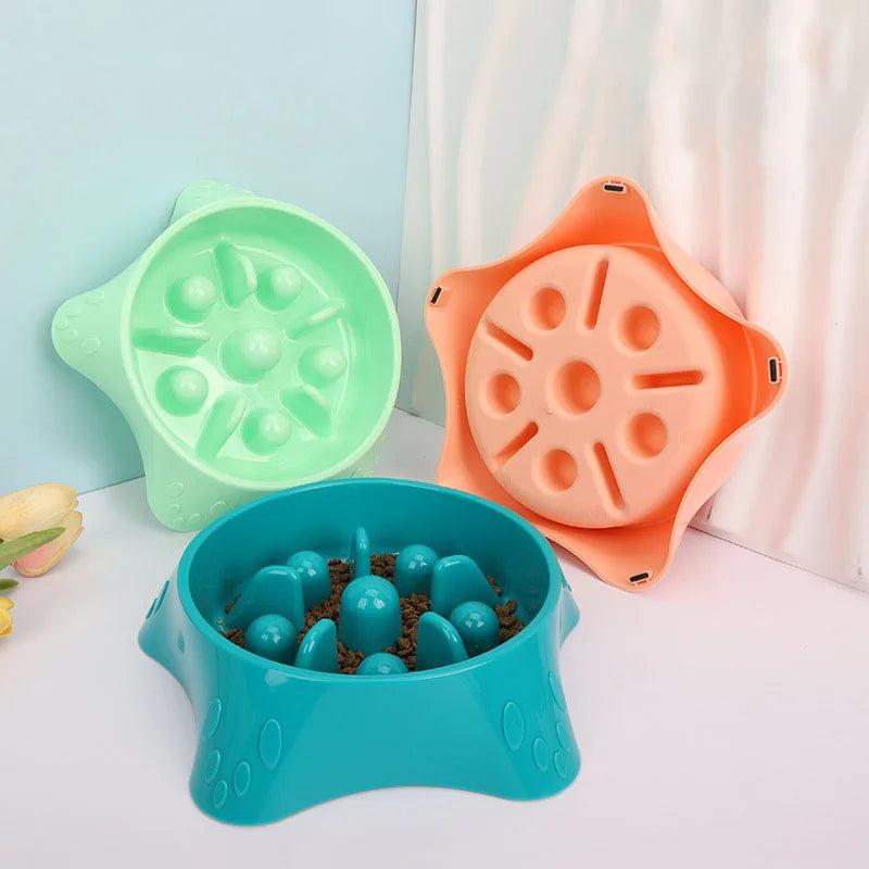 Three silicone puzzle feeding dishes for dogs in green, orange, and blue colors