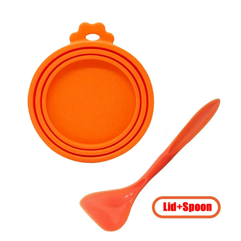 Orange reusable silicone pet food can lid with a matching spoon