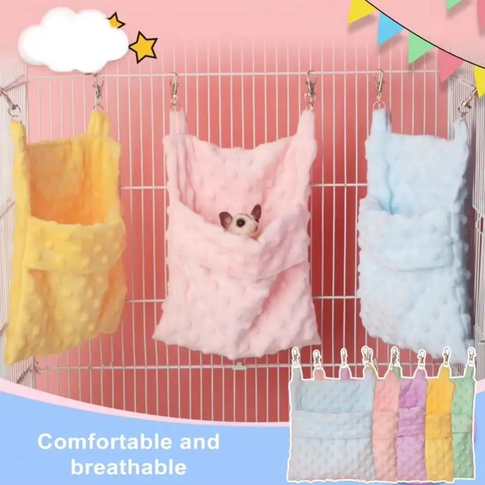 A set of three fluffy, breathable hanging sleeping bags for small pets in yellow, pink, and blue.