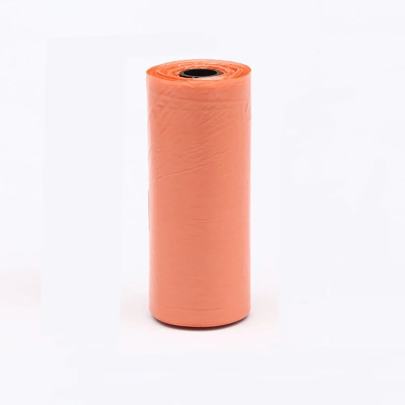A roll of multi-color continuous dog poop bags in a terracotta orange color.