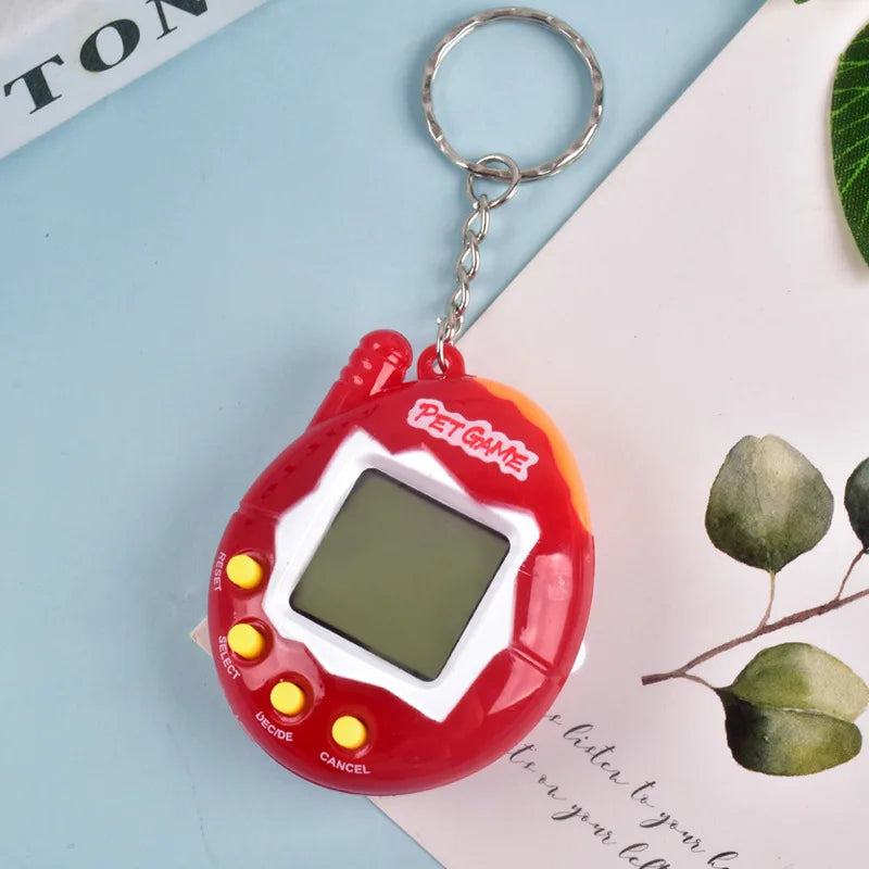 A red digital pet toy with a clear screen and a metal keyring is shown on a light blue surface.