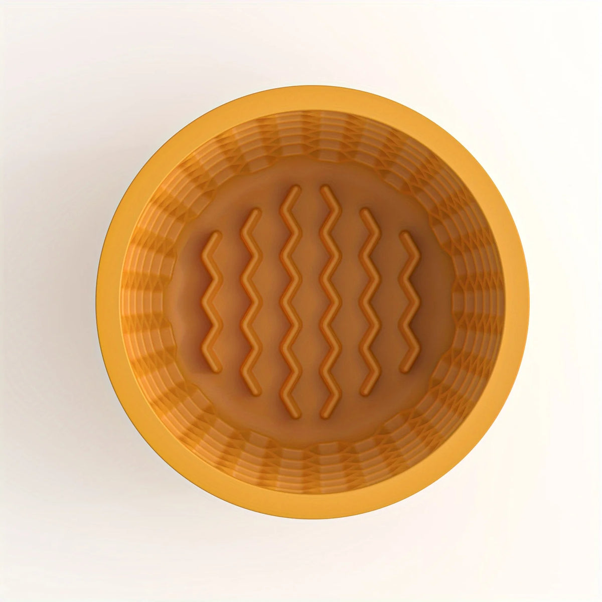 A round, orange silicone slow feeder dog bowl with textured ridges.