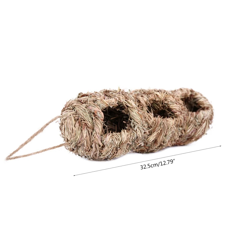 A bundle of natural grass used as a hanging bird nest with a string attached.